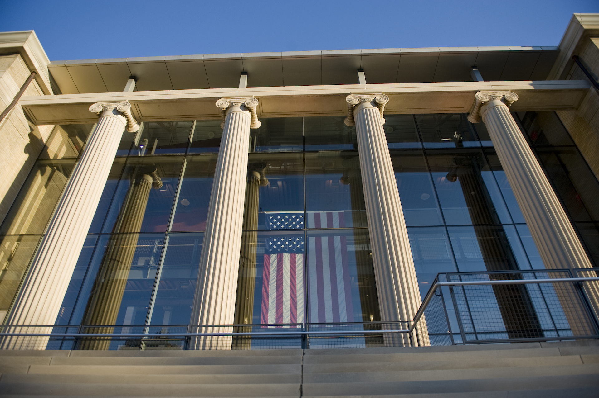 Picture of the front of Page Hall shows columns, American flag hanging vertically