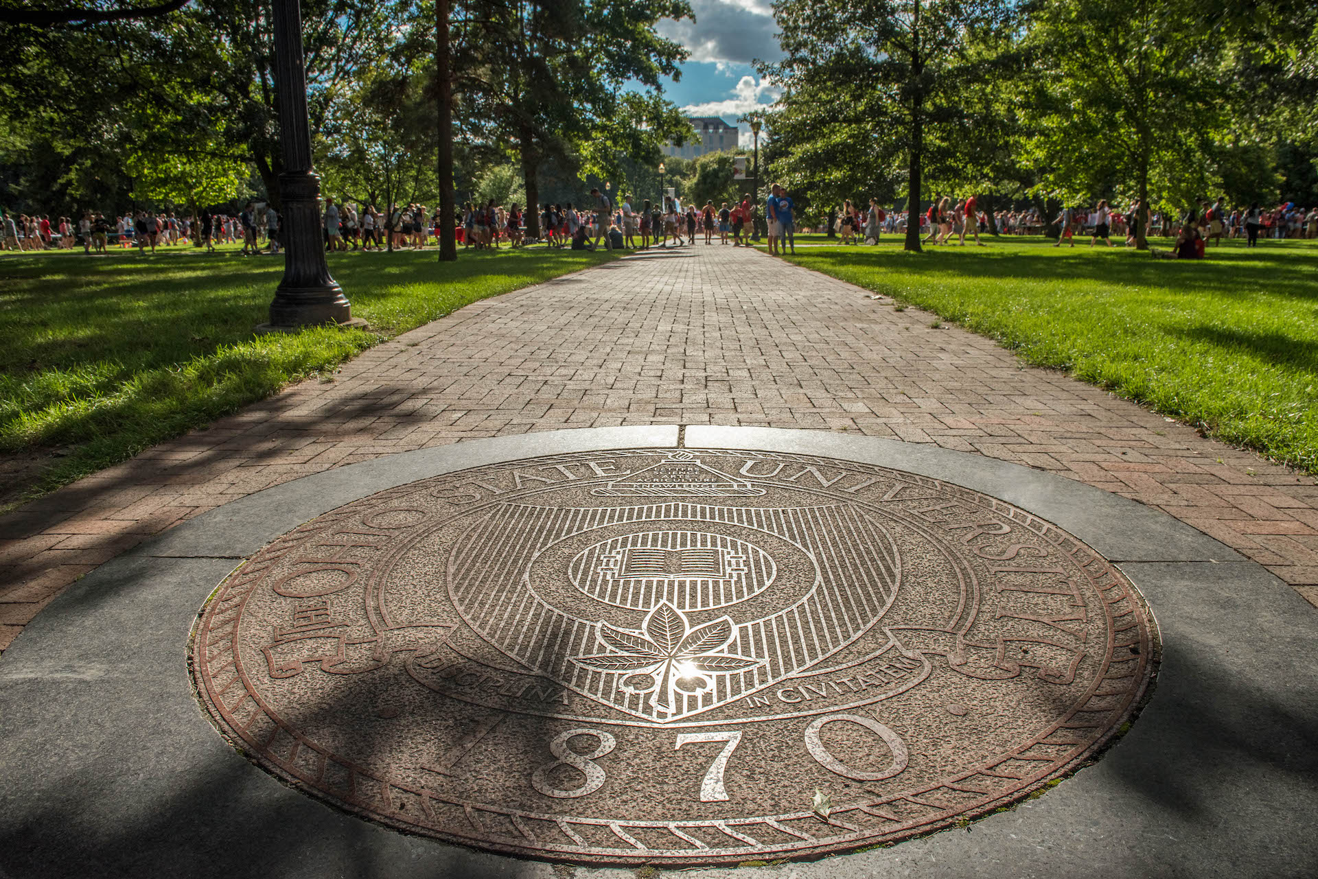 Picture of the seal of The Ohio State University on a brick walkway in the Oval.