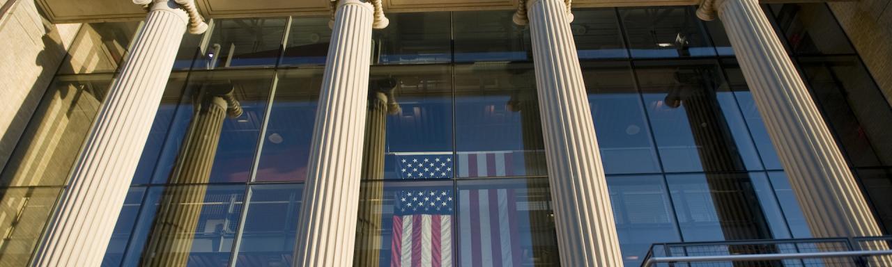 Picture of the front of Page Hall shows columns, American flag hanging vertically