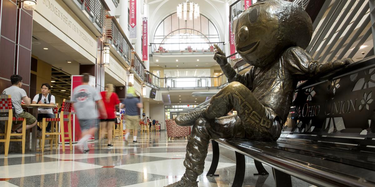 Brutus Buckeye statue sits on a bench in the Ohio Union.